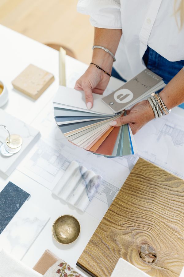 Photo showing a woman holding paint swatches